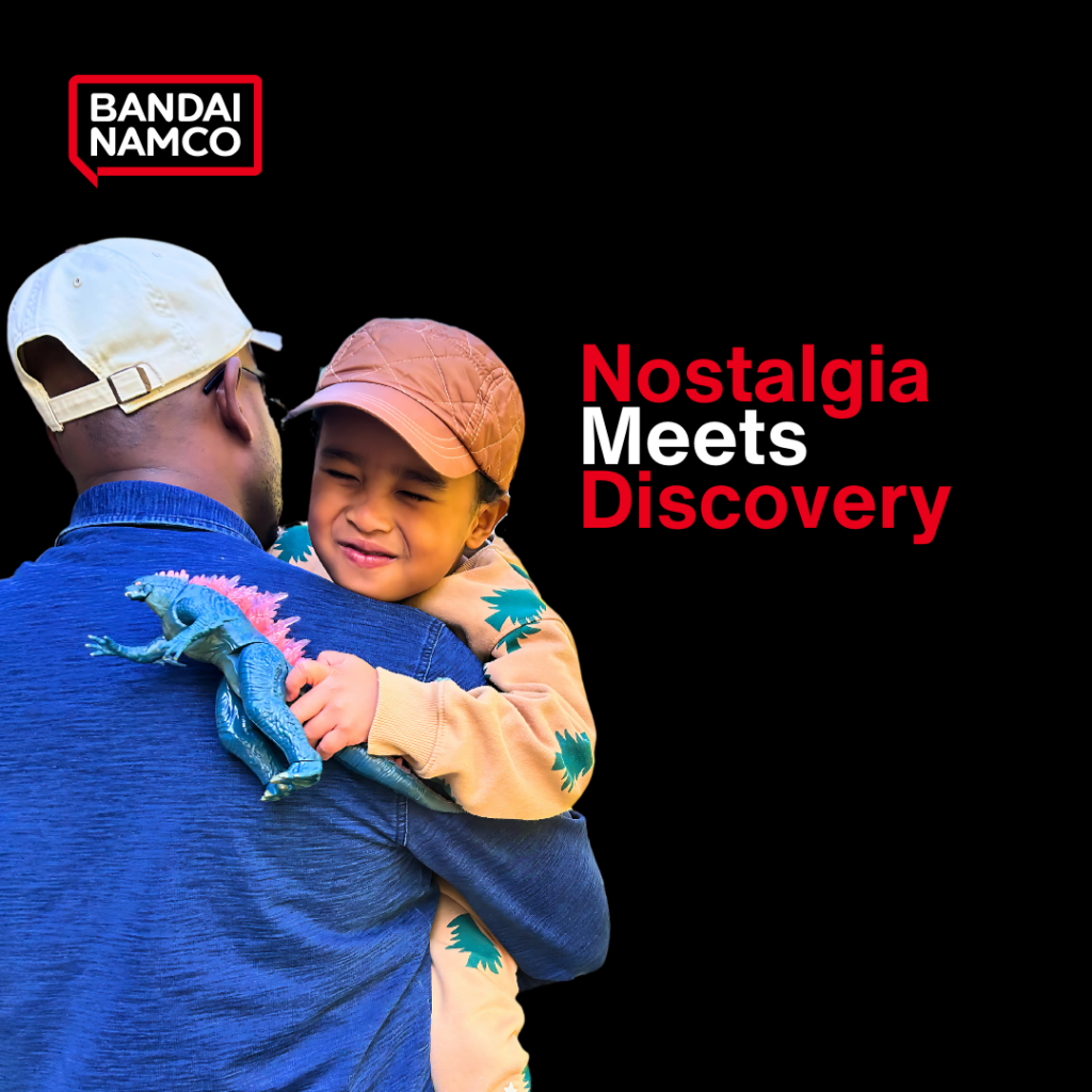 Kid holding a Godzilla toy with father